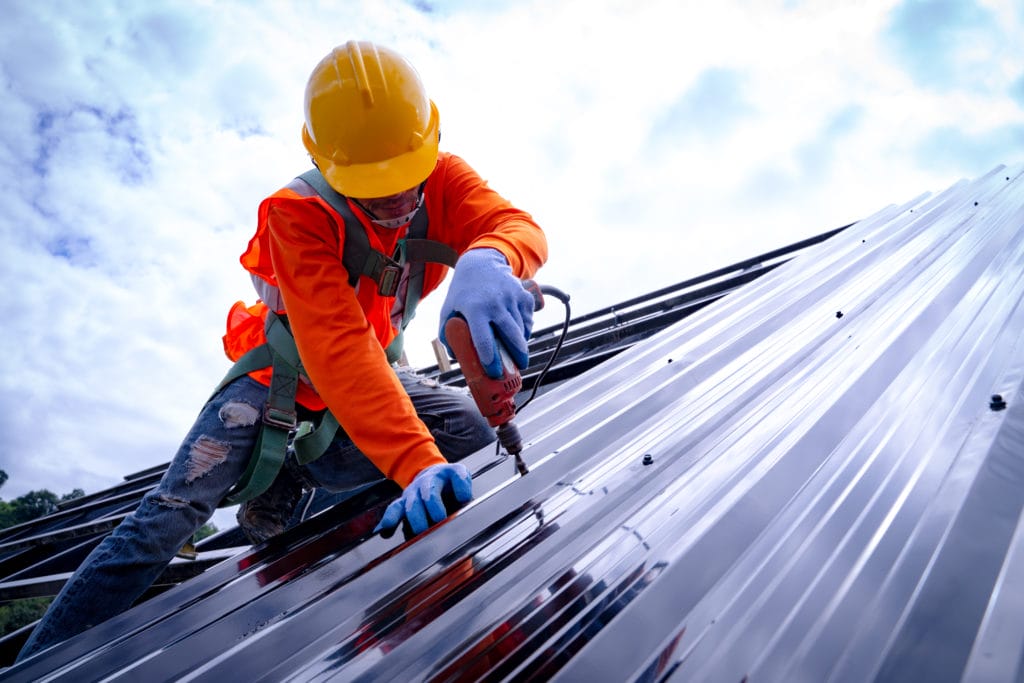 Construction Worker Performing Roofing Services