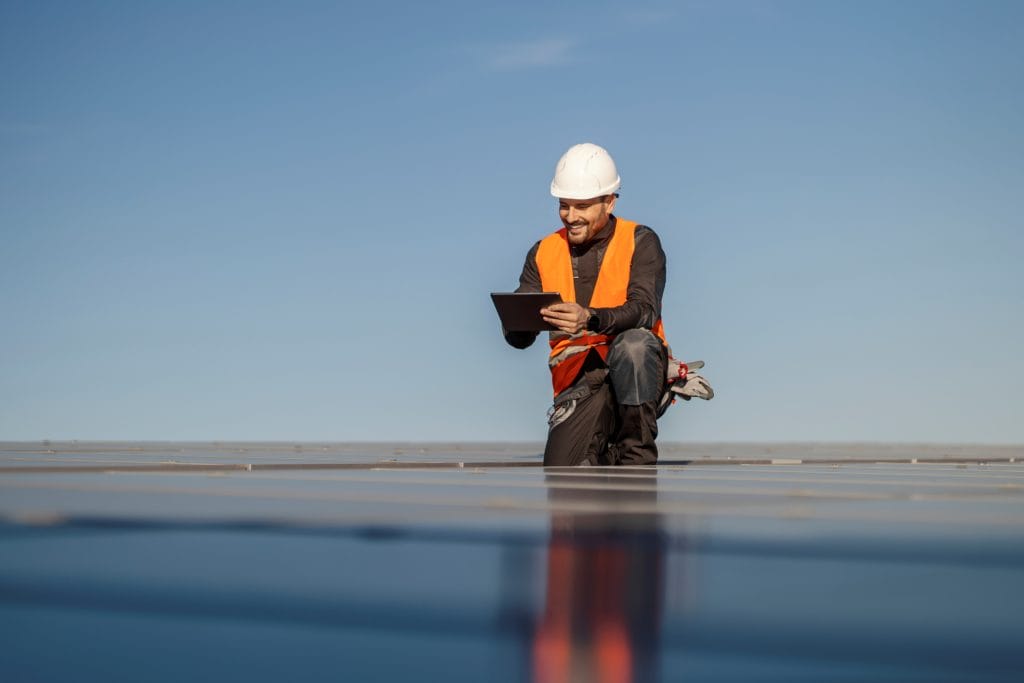 An Expert Performing Field Testing Services On A Roof